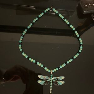 An amazing handmade necklace with a beautiful dragonfly in the middle.